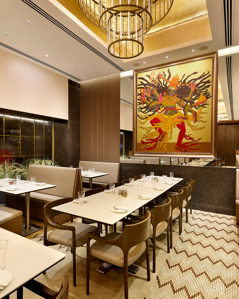 Interior of a modern restaurant with warm lighting and wooden furniture.